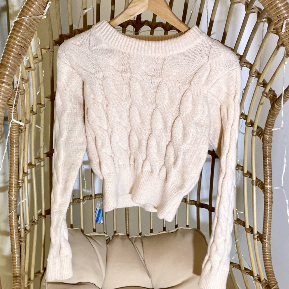 Cream cable knit sweater.